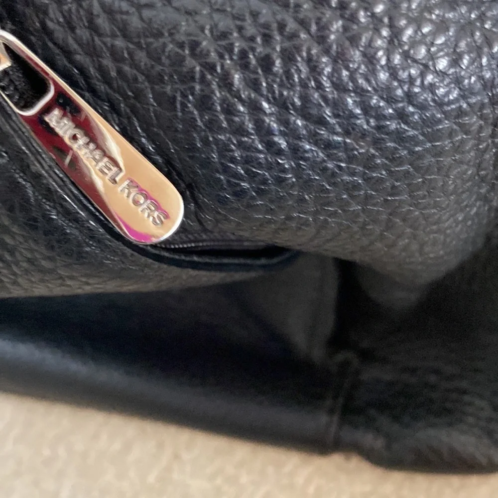 Michael Kors black leather shoulder bag, silver hardware logo on zipper, clean